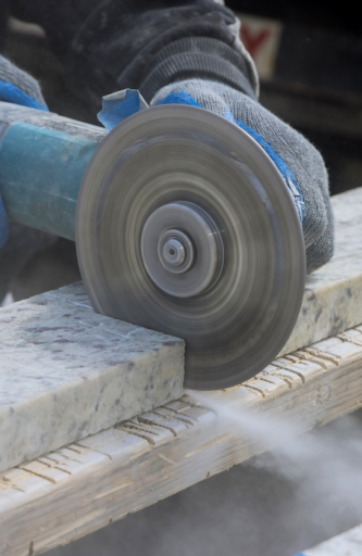 a worker cutting tile